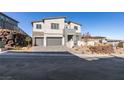 Contemporary two-story home with stone accents, three-car garage, and landscaped front yard at 522 Riley Ridge Ct, Henderson, NV 89012