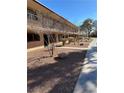 A sunny view of an apartment community and sidewalk with green grass at 575 S Royal Crest Cir # 18, Las Vegas, NV 89169