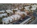 Aerial view of the condominium complex with a parking lot, landscaping, and nearby houses at 6800 E Lake Mead Blvd # 1126, Las Vegas, NV 89156