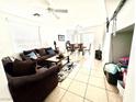 Bright and airy living room with tile floors, a ceiling fan, and a view into the dining area at 6819 Mahogany Meadows Ave, Las Vegas, NV 89122