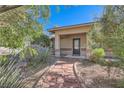 Charming front entrance featuring a stone walkway and covered porch, surrounded by mature desert landscaping at 6925 Donald Nelson Ave, Las Vegas, NV 89131