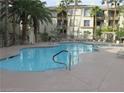 Community pool with ample lounge seating and lush landscaping at 7123 S Durango Dr # 206, Las Vegas, NV 89113