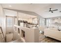 Stylish living room and kitchen combo with white furniture, modern appliances, and a sleek design at 7250 Diamond Canyon Ln # 204, Las Vegas, NV 89149