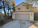 Charming two-story home featuring a red tile roof, neutral stucco, and a spacious two-car garage with a wide driveway at 7509 Wheat Grass Ct, Las Vegas, NV 89129