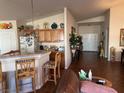 Inviting eat-in kitchen featuring a breakfast bar, light wood cabinets, and easy access to other rooms at 9204 Gentle Cascade Ave, Las Vegas, NV 89178