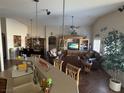 Open-concept living room with a ceiling fan, entertainment center, and access to the kitchen at 9204 Gentle Cascade Ave, Las Vegas, NV 89178