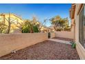 Private rear yard with rock landscaping, a privacy wall, and mature shade trees at 9564 Belle Fountain Ave, Las Vegas, NV 89123