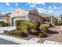 Inviting single-story home showcasing desert landscaping, a garage, and a beautiful tile roof at 7400 Quail Heights Ave, Las Vegas, NV 89131