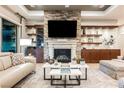 Cozy living room with modern fireplace, built-in cabinets, shelves, and a comfortable seating area at 10507 Bryn Haven Ave, Las Vegas, NV 89135