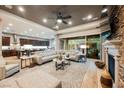 Spacious living room features a stone fireplace, hardwood floors, and sliding glass doors to the backyard at 10507 Bryn Haven Ave, Las Vegas, NV 89135
