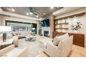 Bright living room with fireplace, wood floors, built-in shelving, and backyard views through sliding glass doors at 10507 Bryn Haven Ave, Las Vegas, NV 89135