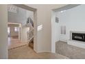 Open-concept living space featuring staircase, fireplace, and tile flooring at 10530 Eagle Nest St, Las Vegas, NV 89141