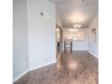 Open-concept living area with hardwood floors, leading to a modern kitchen at 10550 W Alexander Rd # 2057, Las Vegas, NV 89129