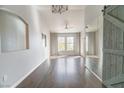 Bright living room featuring hardwood floors, large windows, and modern ceiling fans at 10550 W Alexander Rd # 2057, Las Vegas, NV 89129