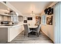 Cozy dining area adjacent to the kitchen, featuring modern light fixtures and a view of the backyard at 1228 Mews Ln, Las Vegas, NV 89101