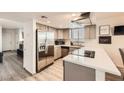 Well-lit kitchen features stainless steel appliances, gray shaker cabinets, and bright white countertops at 1228 Mews Ln, Las Vegas, NV 89101