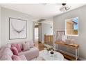Cozy living room featuring a comfortable pink sofa, a decorative table, and bright natural light at 2276 Laramine River Dr, Henderson, NV 89052