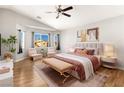 Bright main bedroom with a sitting area, a large window, and light wood flooring at 2276 Laramine River Dr, Henderson, NV 89052
