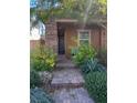 Inviting front porch with brick pathway and lush landscaping leading to the entrance at 257 Homeward Way, Henderson, NV 89011