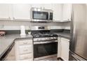 Updated kitchen featuring stainless steel appliances, white cabinets, and solid surface countertops at 3038 Tarpon Dr # 102, Las Vegas, NV 89120