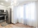 Bright kitchen featuring stainless steel appliances, white cabinets, and wood-look floors at 3038 Tarpon Dr # 102, Las Vegas, NV 89120