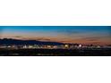 Panoramic view of the Las Vegas Strip at night, showcasing illuminated hotels and desert mountains at 438 Serenity Point Dr, Henderson, NV 89012