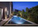 Backyard pool with water features and landscaping offers a tranquil outdoor retreat with modern design at 438 Serenity Point Dr, Henderson, NV 89012