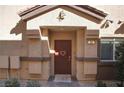 Inviting front door with decorative accents, textured walls, and a well-maintained entryway at 4705 Blaise Ave # 101, North Las Vegas, NV 89084