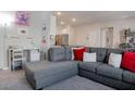 Cozy living room with sectional sofa, work desk, and open layout for versatile living space at 4705 Blaise Ave # 101, North Las Vegas, NV 89084