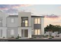 Contemporary two-story townhome showcasing a stone facade, balcony, and professionally landscaped front yard at 5729 Crenellated St # Lot 68, Las Vegas, NV 89148