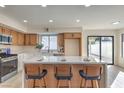 Kitchen featuring an island with seating and stainless appliances, plus outdoor access at 6 Megan Dr, Henderson, NV 89074