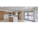 Bright, open kitchen with island, stainless steel appliances and a view of the backyard at 6 Megan Dr, Henderson, NV 89074