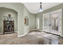 Elegant foyer with decorative double doors, marble floors, and arched doorways, showcasing a welcoming entrance at 6392 Ebony Legends Ave, Las Vegas, NV 89131