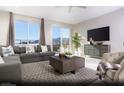 Comfortable living room features a large sectional sofa, plush rug and mountain views at 6826 Sweet Bay St # Lot 10, Las Vegas, NV 89166