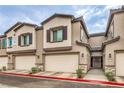 Street view of desert-landscaped townhomes with attached two car garages at 7232 N Decatur Blvd # 4, Las Vegas, NV 89131