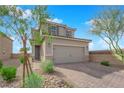 Inviting two-story home featuring a brick driveway and a well-maintained front yard at 8495 Green Alder Ct, Las Vegas, NV 89113