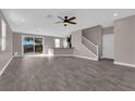 Spacious living room with stylish tile flooring and sliding glass doors to the backyard at 8495 Green Alder Ct, Las Vegas, NV 89113