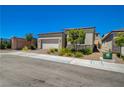 Charming single-story home featuring a two-car garage, brick driveway, stone accents and landscaped front yard at 8525 Stokestone St, Las Vegas, NV 89166