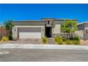 Charming single-story home featuring a two-car garage, brick driveway, stone accents and landscaped front yard at 8525 Stokestone St, Las Vegas, NV 89166