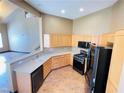 Well-lit kitchen boasts light wood cabinetry, modern appliances, and an open layout at 8777 W Maule Ave # 2167, Las Vegas, NV 89148