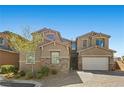 Charming two-story home boasts a stone accent, attached two car garage and a beautifully landscaped front yard at 8895 Dartmouth Grove Ave, Las Vegas, NV 89148