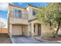 Two-story home featuring front yard, a balcony and an attached garage at 9017 Becoming Ct, Las Vegas, NV 89149