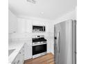 Modern kitchen equipped with stainless steel appliances, white cabinets, and stylish countertops at 9017 Becoming Ct, Las Vegas, NV 89149
