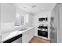 Modern kitchen equipped with stainless steel appliances, white cabinets, and stylish countertops at 9017 Becoming Ct, Las Vegas, NV 89149