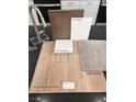 Sample board displaying kitchen finishes, including cabinets, countertop, flooring and carpet at 10012 River Corral St, Las Vegas, NV 89166