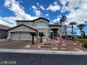 Charming two-story home featuring a stucco exterior, a two-car garage, and landscaped front yard with desert plants at 10134 Reflection Brook Ave, Las Vegas, NV 89148