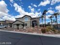 Charming two-story home featuring a stucco exterior, a two-car garage, and landscaped front yard with palm trees at 10134 Reflection Brook Ave, Las Vegas, NV 89148