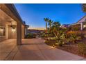 Exterior with desert landscaping, covered patio, and exterior lighting at 1992 Fort Halifax St, Henderson, NV 89052