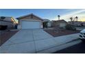 Single story house with a wide concrete driveway leading to an attached garage at 213 Beaver Ridge Ave, North Las Vegas, NV 89031
