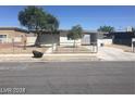 Inviting single-story home with a clean facade, open carport, and gravel front yard at 2705 Howard Dr, Las Vegas, NV 89104
